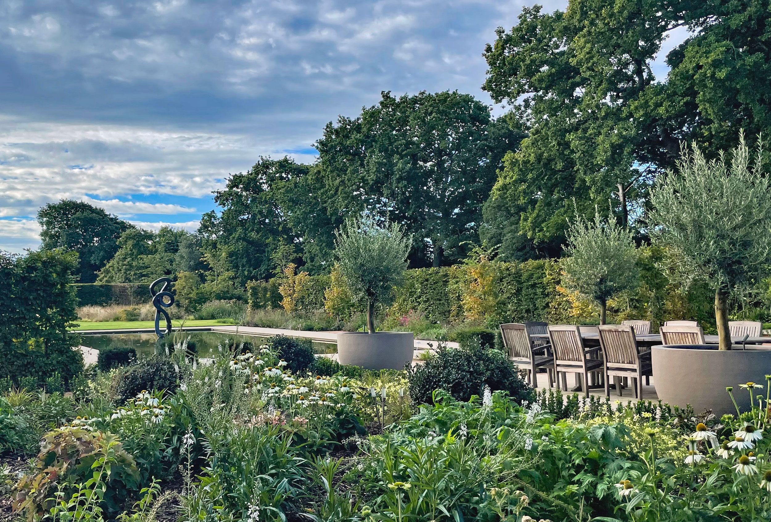 Image may contain: Nature, Outdoors, Scenery, Plant, Grass, Chair, Furniture, Park, Lakefront, Garden, Backyard, and Yard