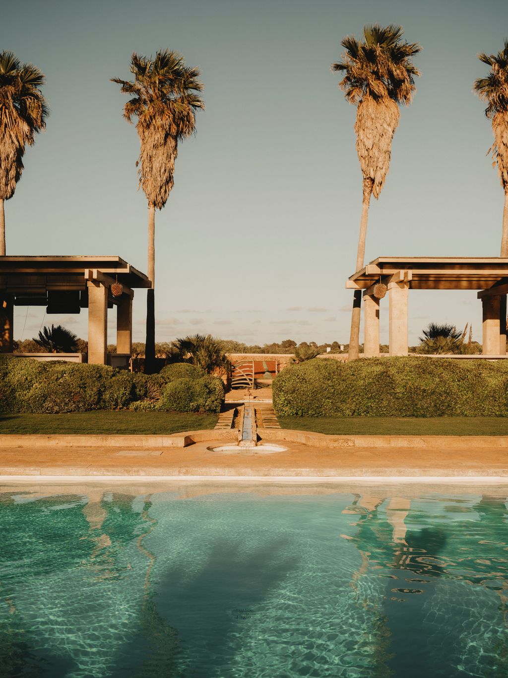 Image may contain Summer Palm Tree Plant Tree Architecture Building Outdoors Shelter Pool Water House and Housing