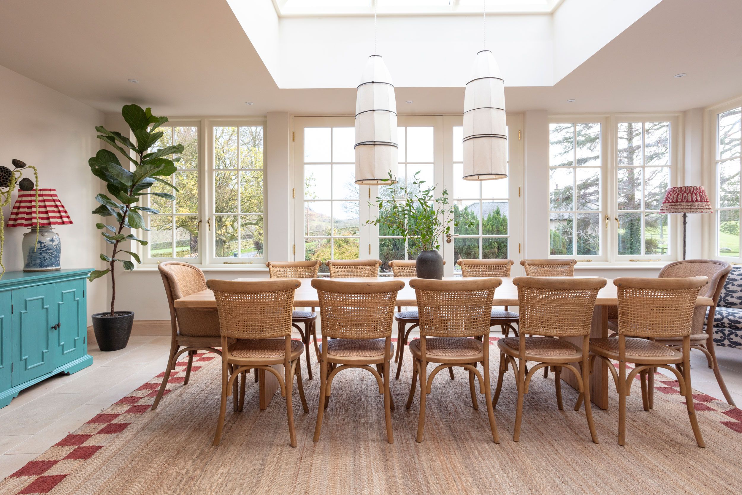 Image may contain: Architecture, Building, Dining Room, Dining Table, Furniture, Indoors, Room, Table, Plant, Lamp, and Chair