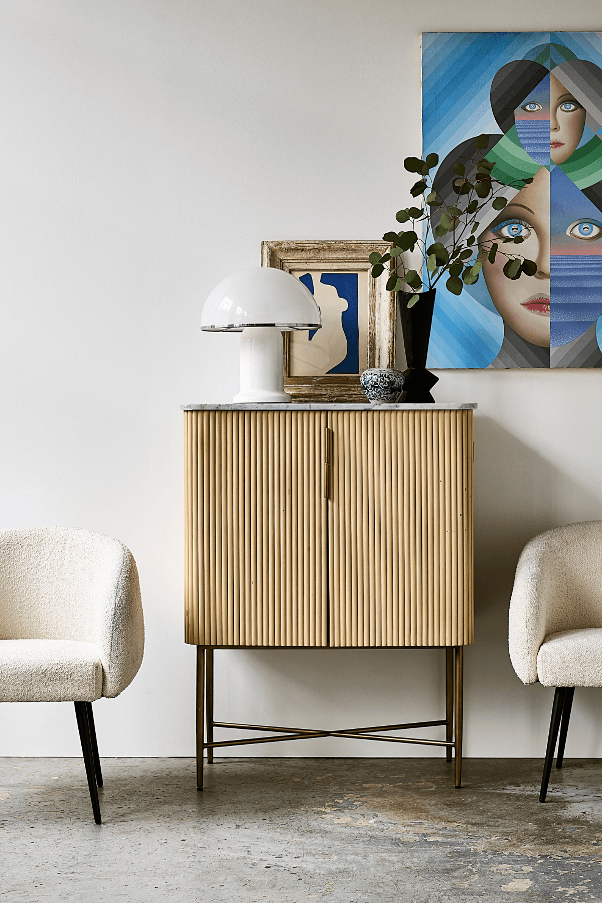 Image may contain: Furniture, Sideboard, Indoors, Interior Design, Lamp, Face, Head, Person, Chair, and Adult