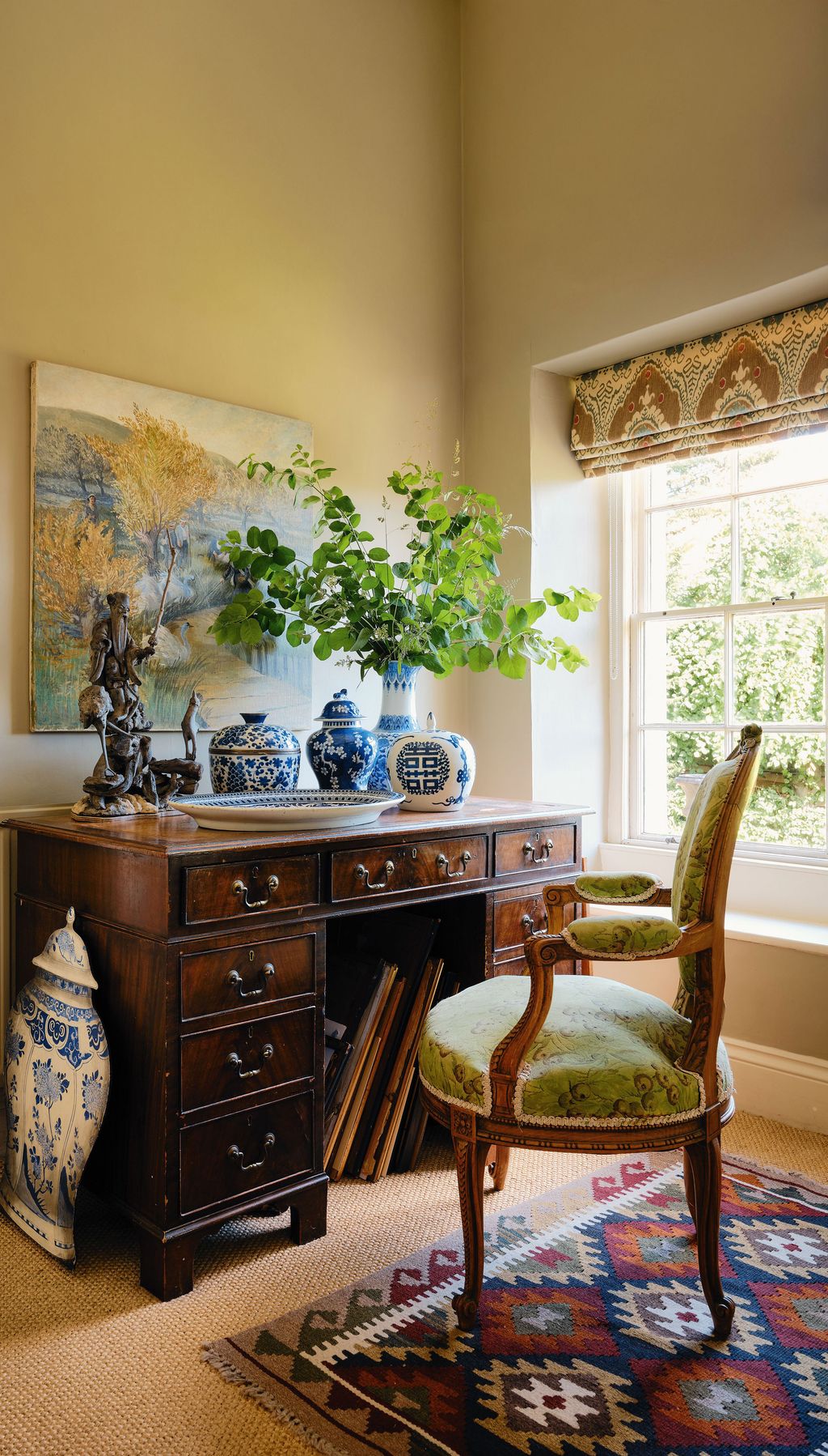 Image may contain Chair Furniture Home Decor Table Rug Plate Plant Indoors Interior Design Person and Sideboard