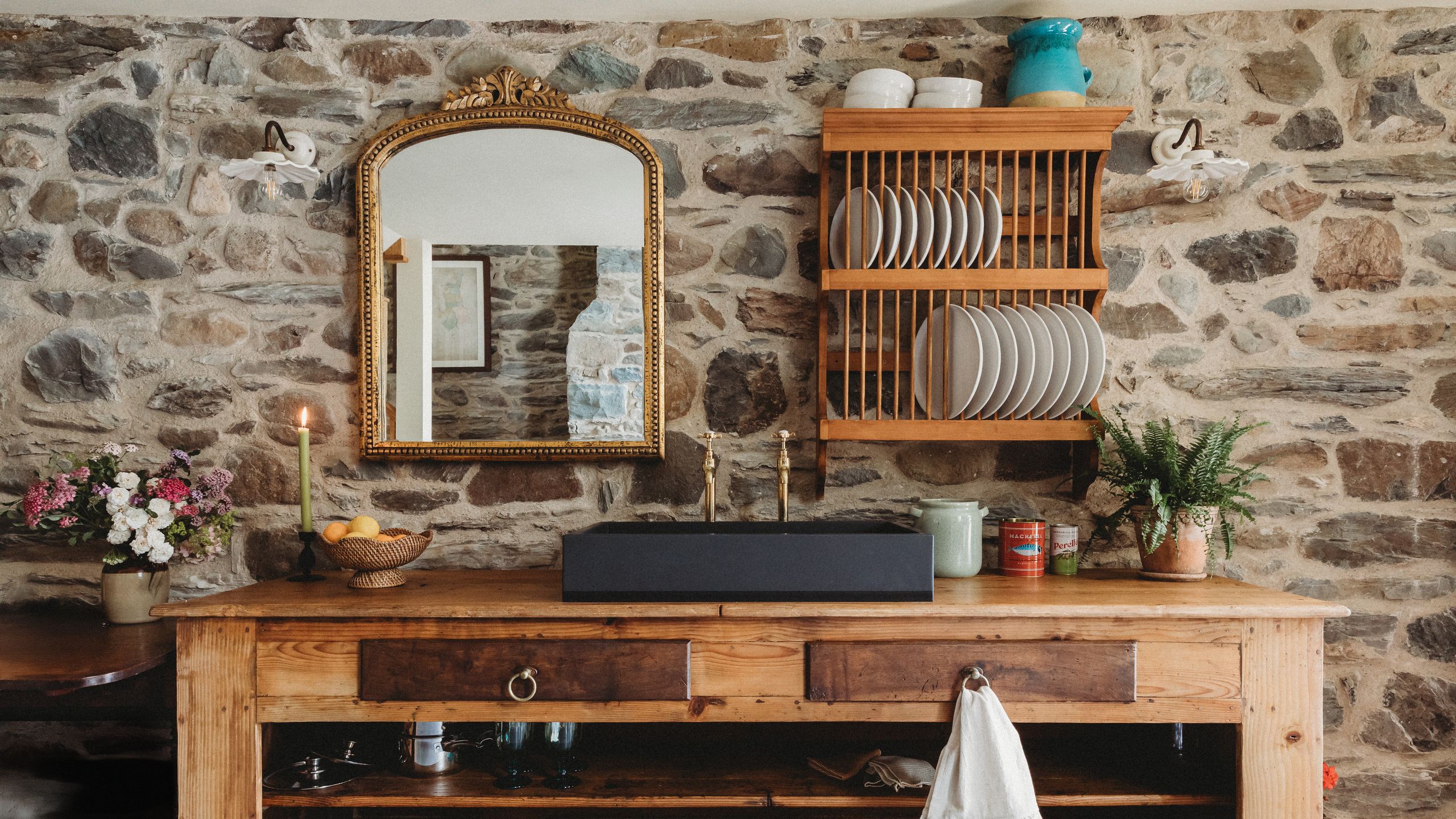 Image may contain: Indoors, Interior Design, Plant, Candle, Cup, Desk, Furniture, Table, Wood, Sideboard, and Plate