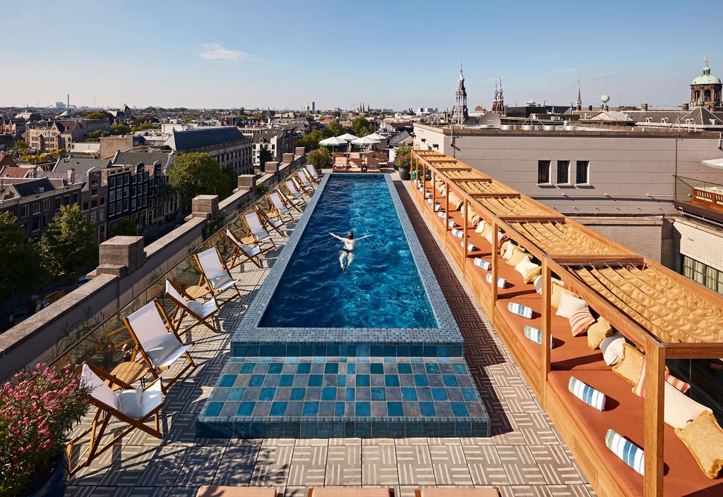 Image may contain Pool Water Swimming Pool Outdoors Aerial View Chair Furniture Person Bread and Food