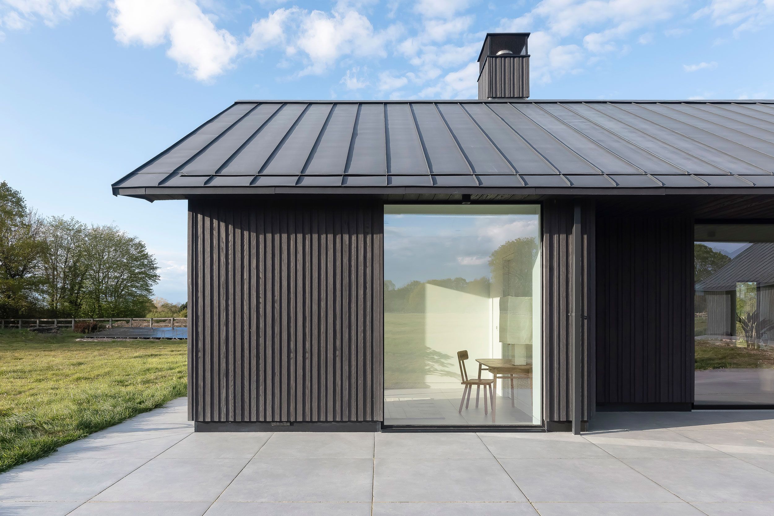 Image may contain: Indoors, Interior Design, Chair, Furniture, Door, Desk, Table, Garage, Architecture, and Building