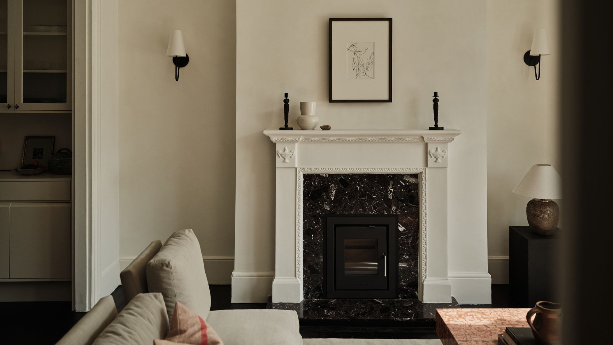 Image may contain: Fireplace, Indoors, Interior Design, Lamp, Cup, Home Decor, and Hearth