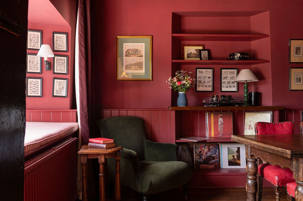 Image may contain Lamp Architecture Building Furniture Indoors Living Room Room Desk Table Art and Painting