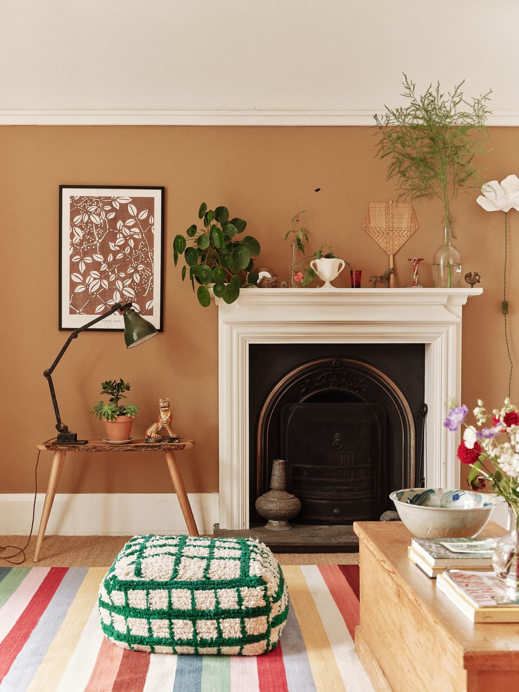 Image may contain Lamp Plant Book Publication Art Painting Cup Desk Furniture Table Home Decor Rug and Fireplace