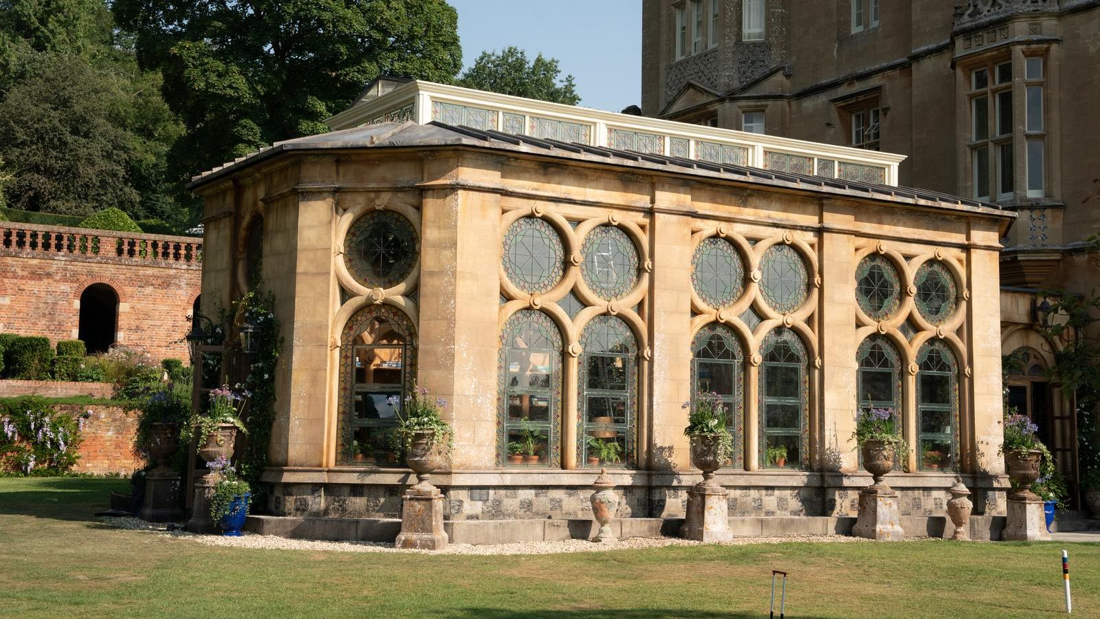 Image may contain Arch Architecture Gothic Arch Grass Plant Building Monastery Housing Outdoors Person and House