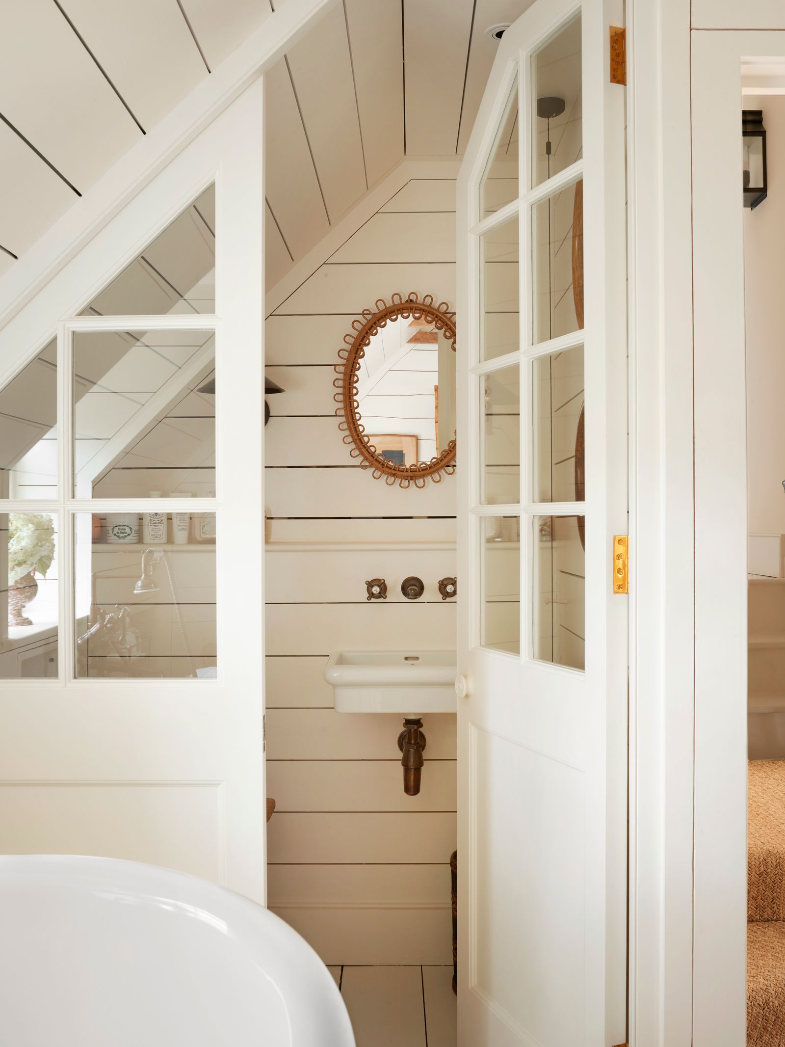 Image may contain Indoors Interior Design Sink Door Wood Panels Bathing Bathtub Person Tub and Architecture