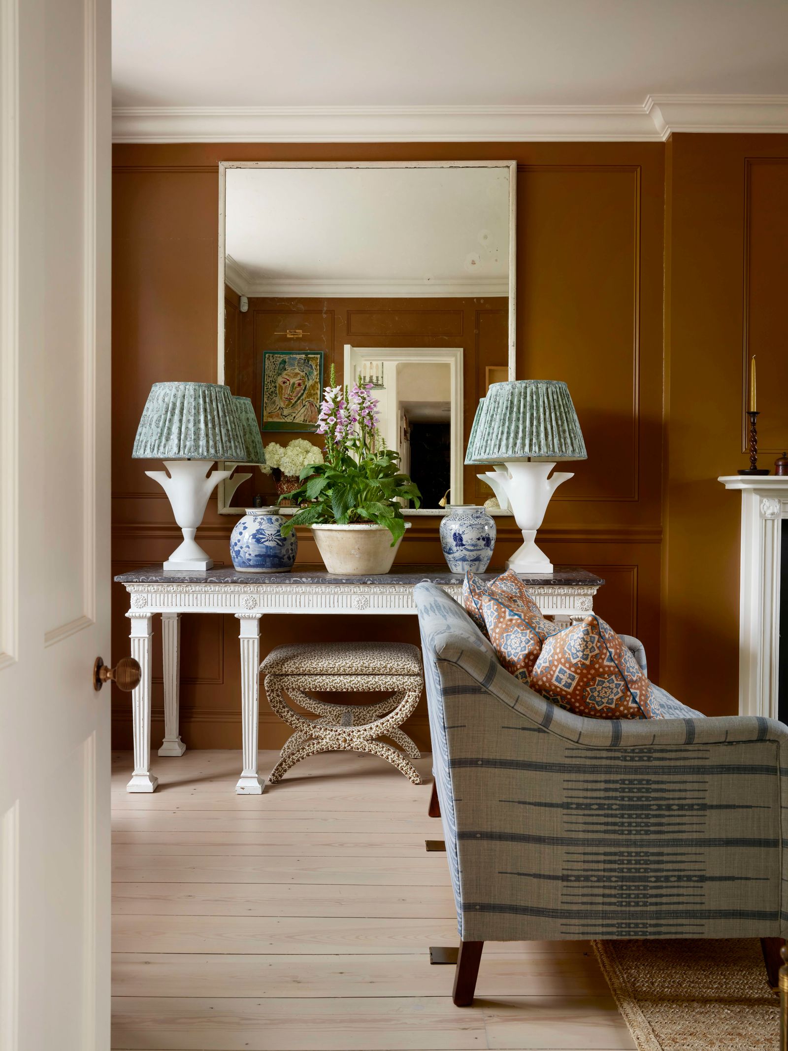 Image may contain Lamp Indoors Interior Design Home Decor Desk Furniture Table Chair Candle Art Painting and Rug