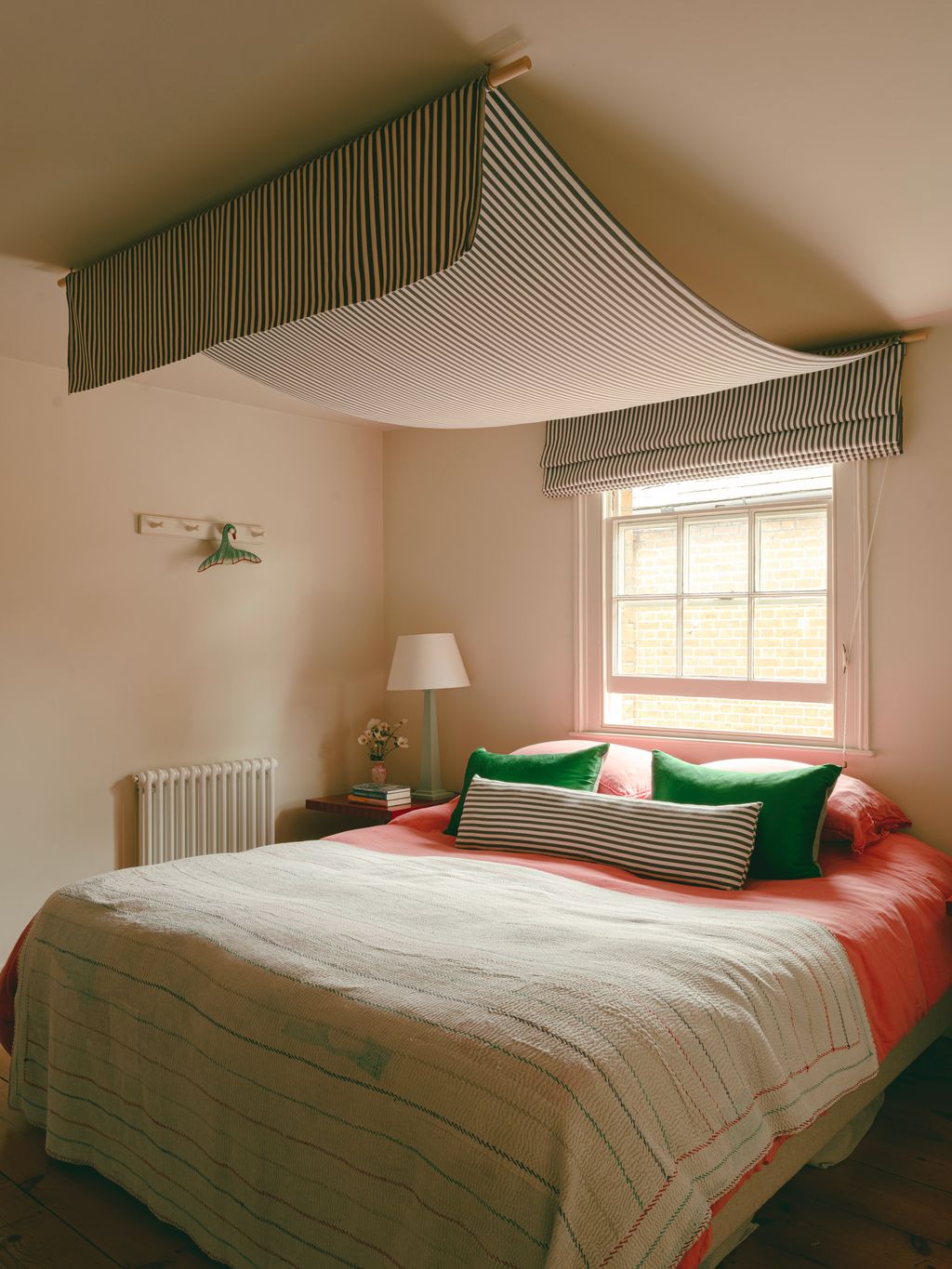 Image may contain Corner Indoors Interior Design Lamp Bed Furniture Home Decor Cushion Bedroom Room and Book