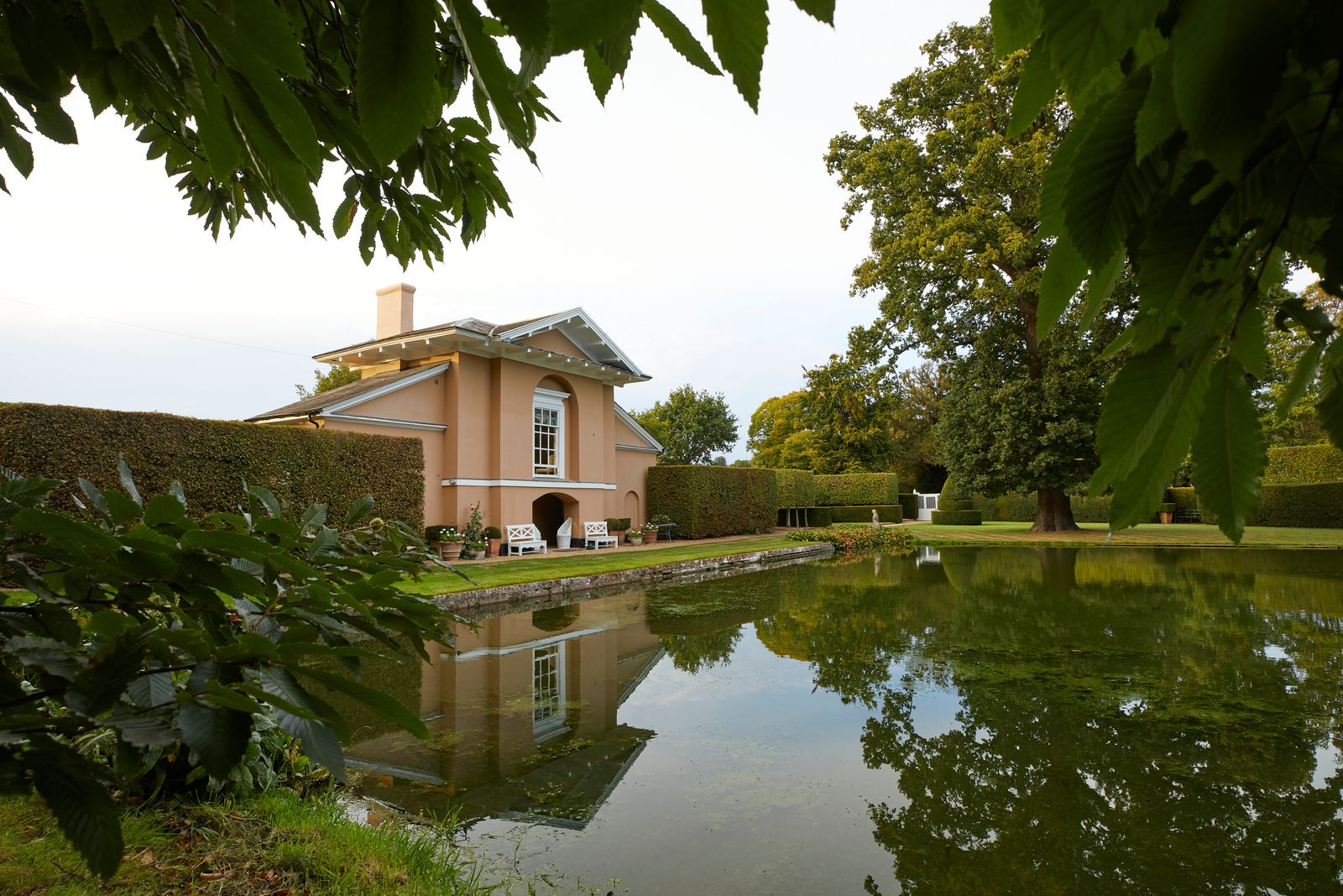 Image may contain Architecture Building House Housing Villa Nature Outdoors Pond Water Scenery and Chair
