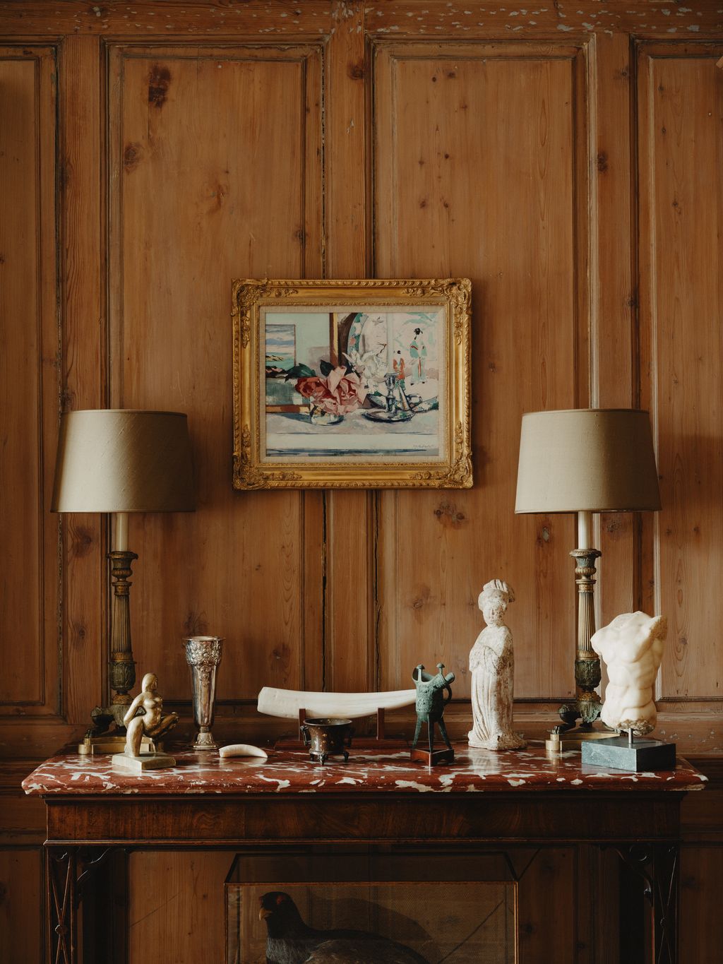 Image may contain Indoors Interior Design Lamp Table Lamp Art Painting Person Wood Animal Bird Chicken and Fowl