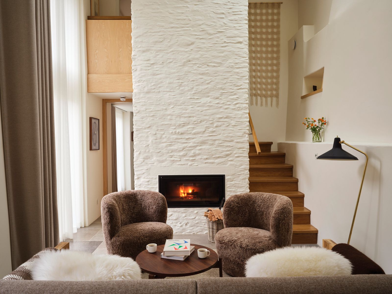 Image may contain Lamp Cup Fireplace Indoors Art Painting Furniture Home Decor Chair Interior Design and Couch