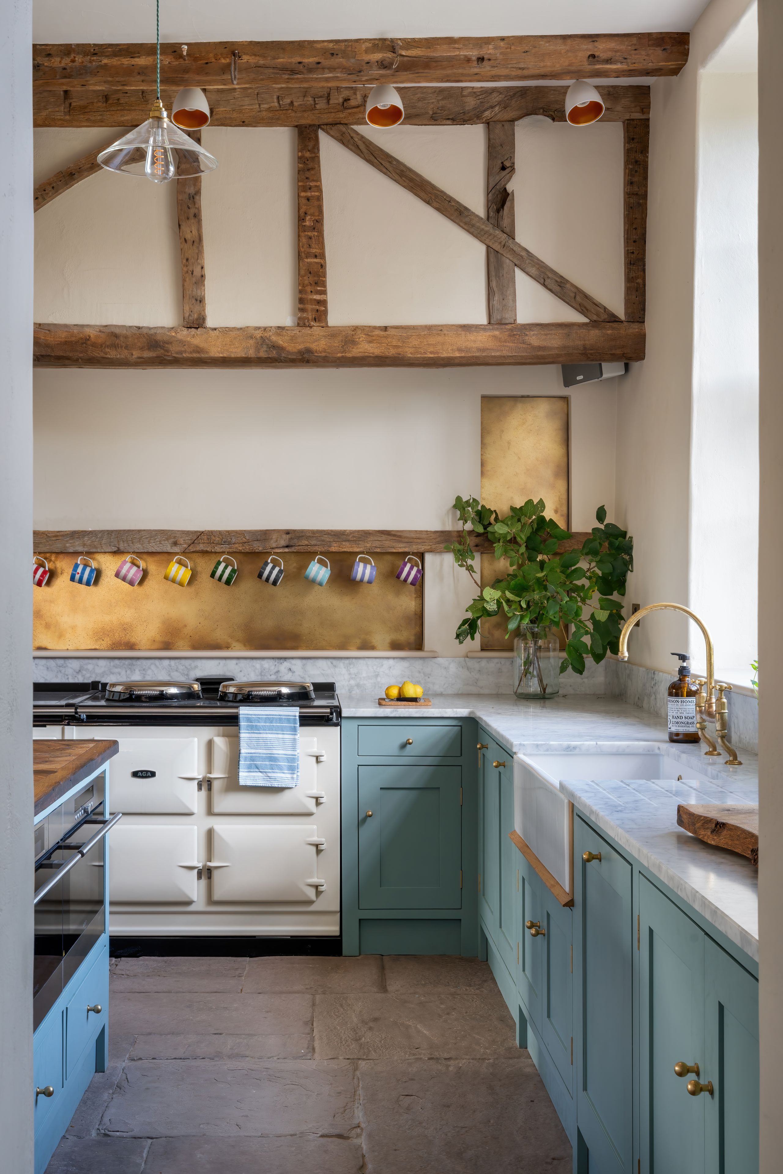 Image may contain: Indoors, Interior Design, Kitchen, Cup, Plant, Sink, Sink Faucet, Lamp, and Cooktop