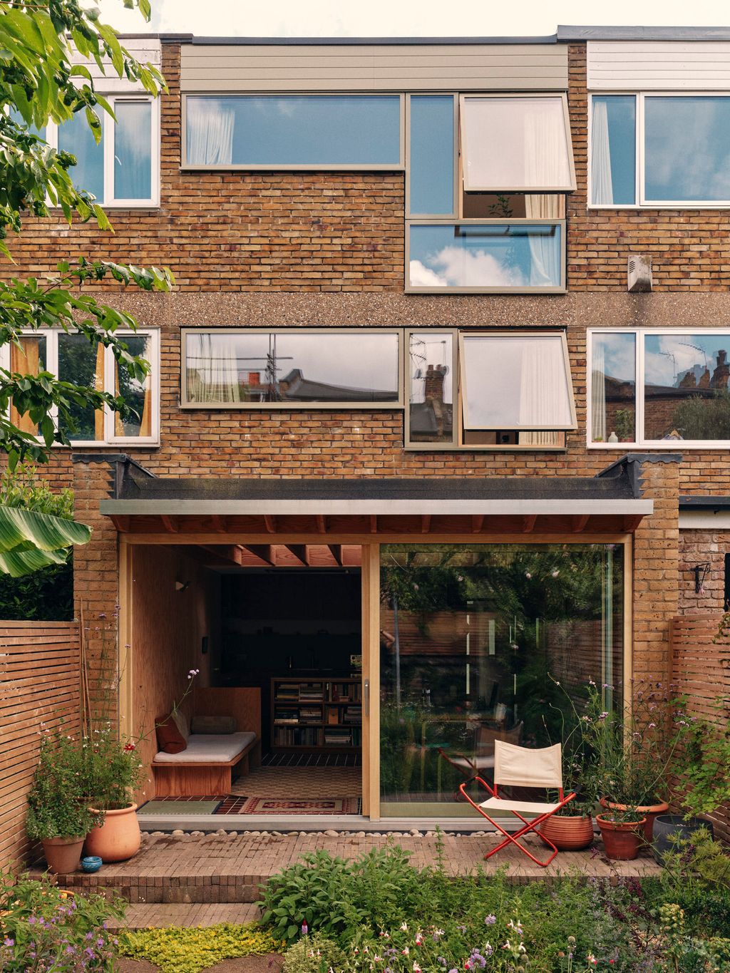 Image may contain Chair Furniture Architecture Building Housing City Indoors Interior Design House and Plant