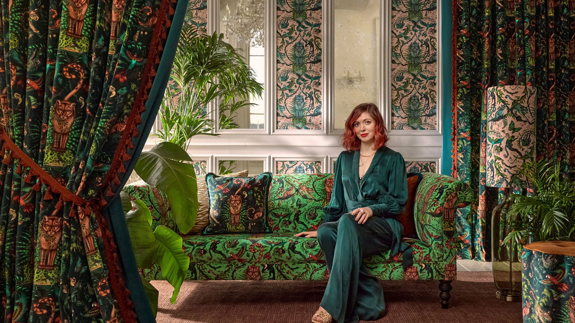 Image may contain: Person, Sitting, Adult, Plant, Accessories, Jewelry, Necklace, Clothing, Footwear, Shoe, and Couch