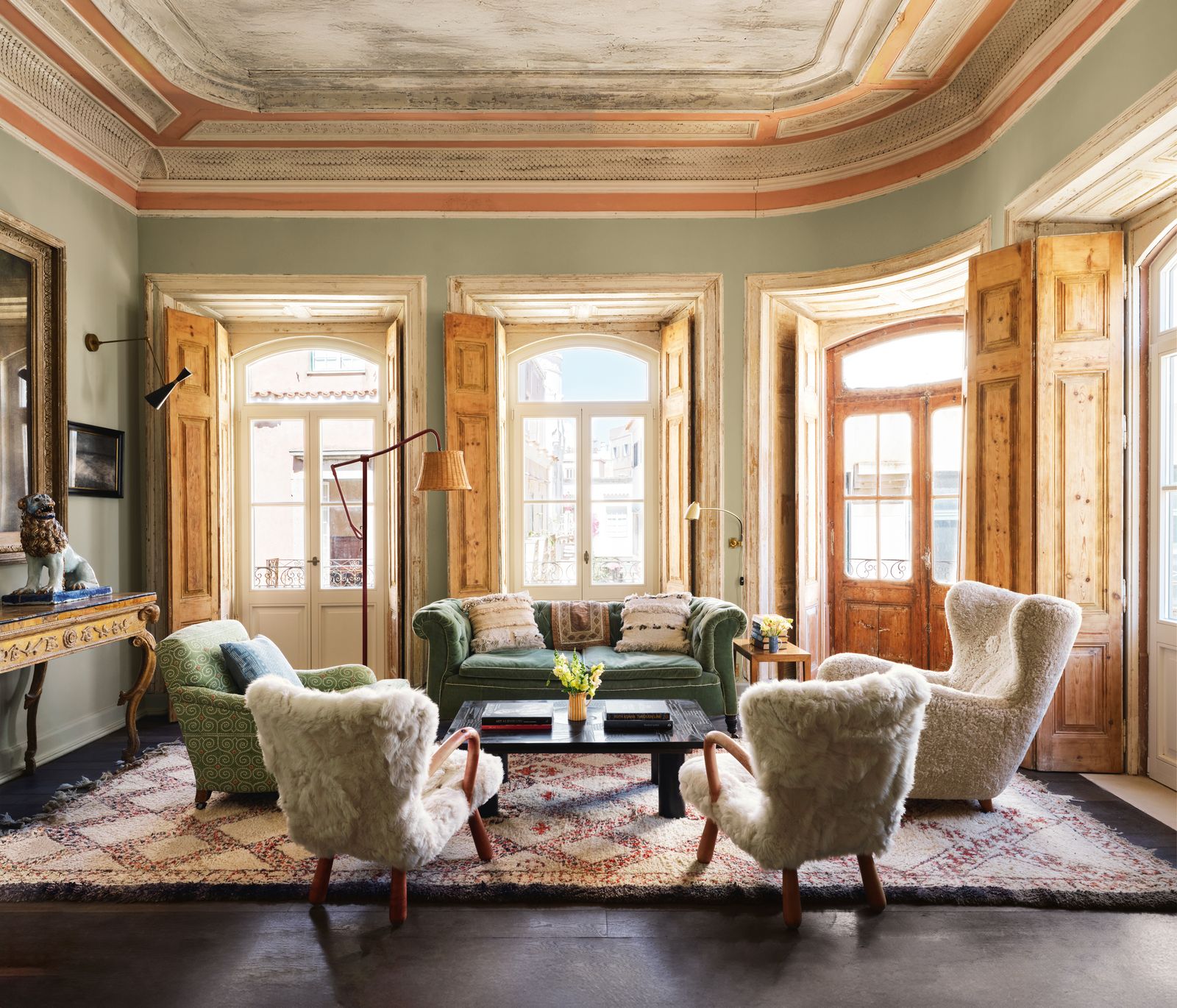 Image may contain Home Decor Lamp Couch Furniture Chair Rug Art Painting Window Plant Desk Table and Indoors