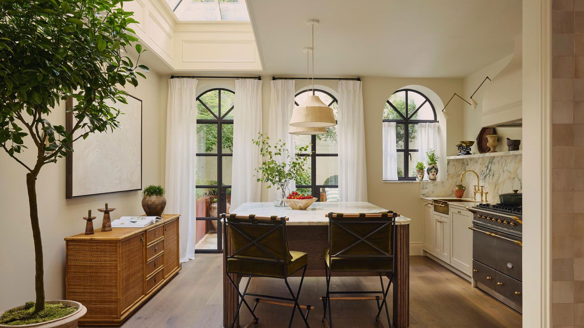 Image may contain: Plant, Indoors, Interior Design, Chair, Furniture, Window, Lamp, Kitchen, Home Decor, and Person