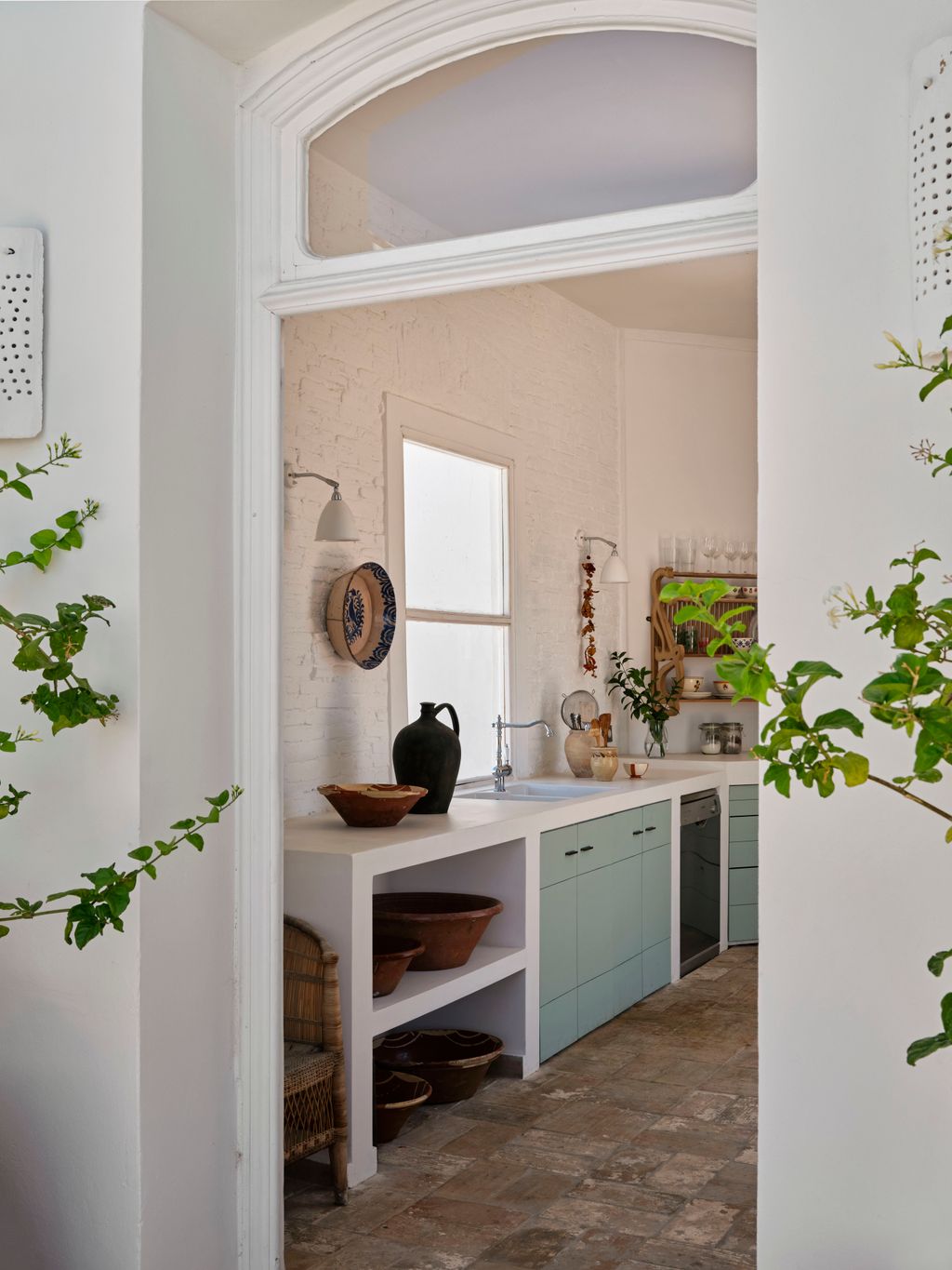 Image may contain Indoors Interior Design Floor Corner Chair Furniture Lamp Sink Sink Faucet and Plant