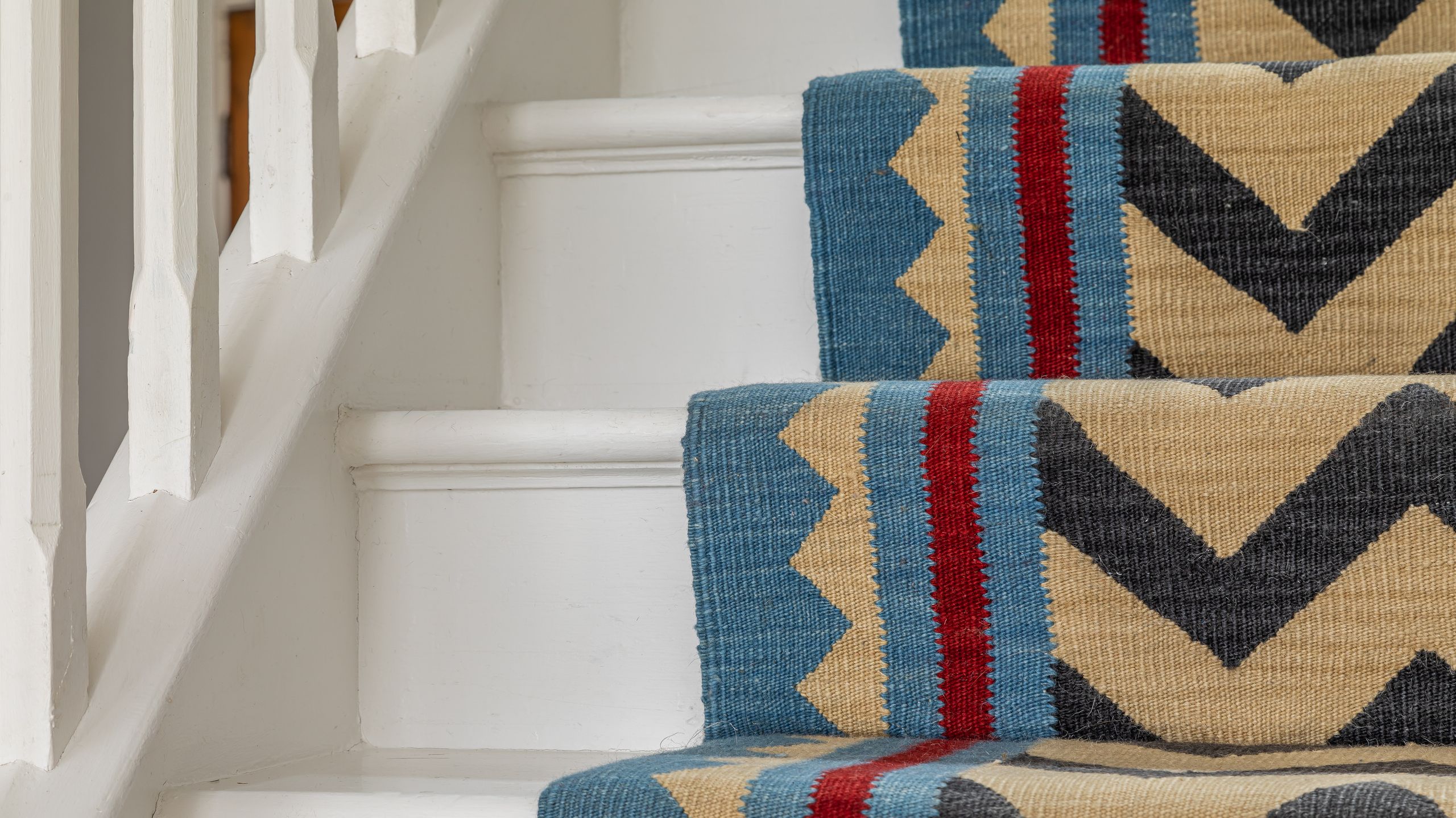 Image may contain: Home Decor, Rug, Architecture, Building, House, Housing, and Staircase