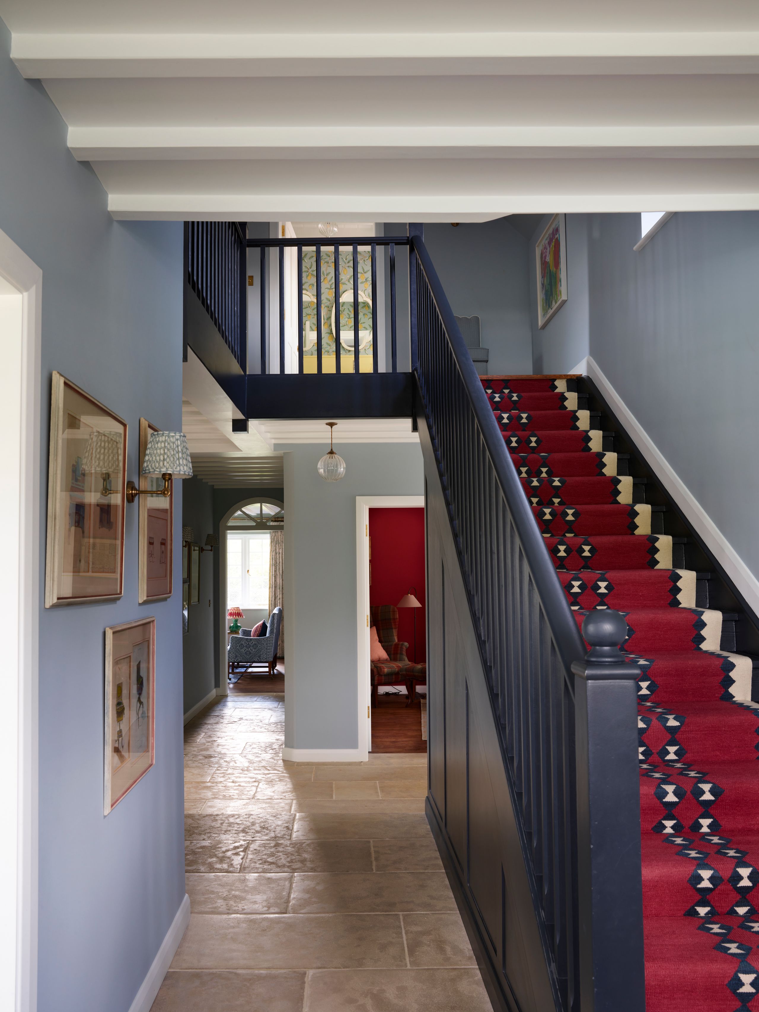 Image may contain: Architecture, Building, House, Housing, Staircase, Lamp, Art, Painting, Indoors, Foyer, and Chair