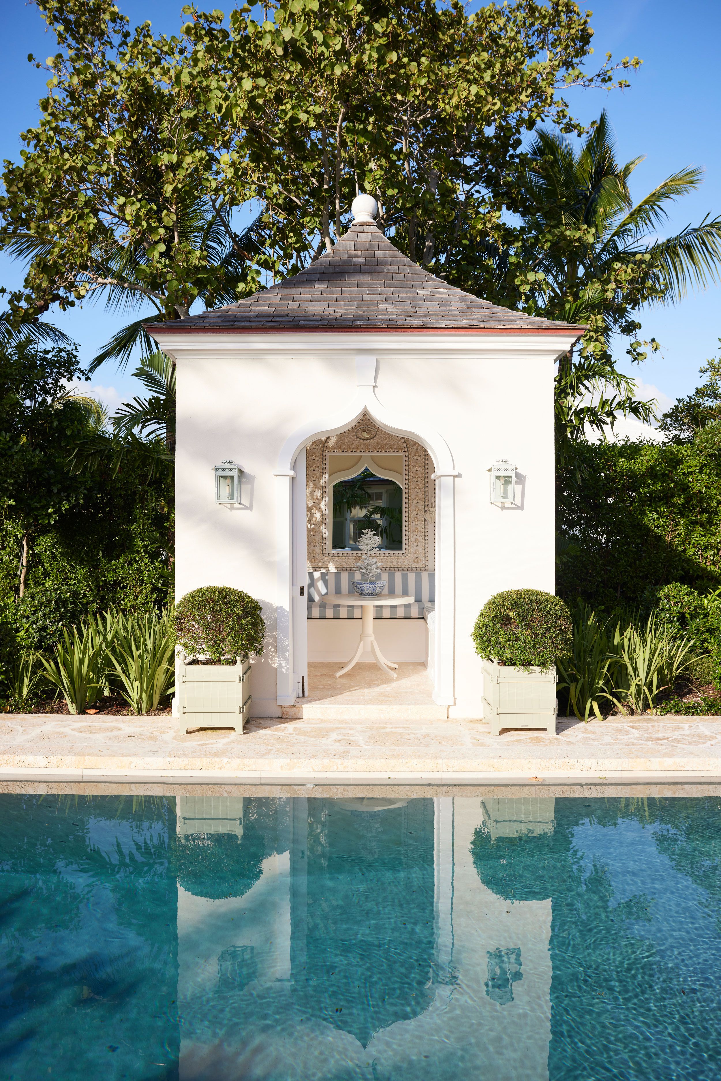 Image may contain: Plant, Desk, Furniture, Table, Architecture, Building, House, Housing, Villa, Summer, Lamp, and Pool