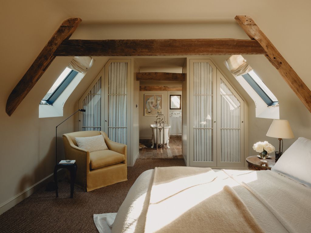 Upstairs the main bedroom has been opened up to flow into the bathroom with wardrobes forming a divider between the...