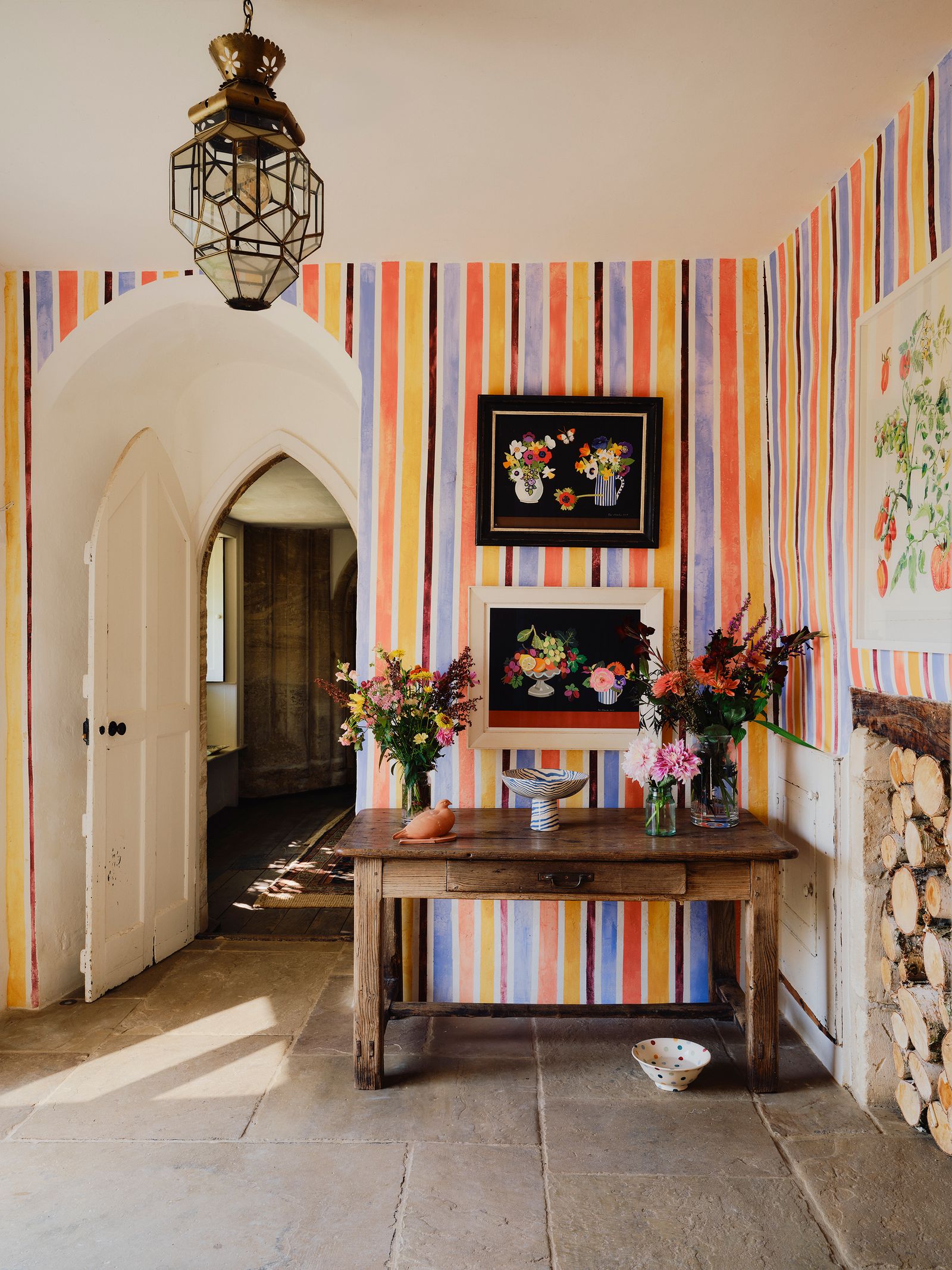 In the hall of Matthew Rices characterful medieval home Ham Court walls in bright stripes painted by his daughter Kitty...