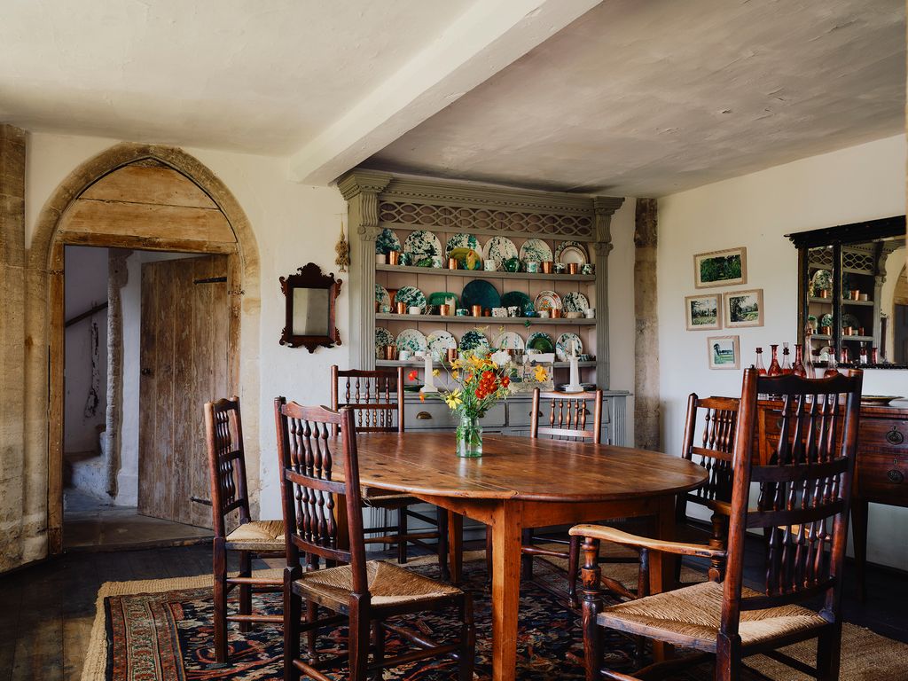 The dining room sits in the medieval part of the house once a much larger castle. The cupboard is filled with colourful...