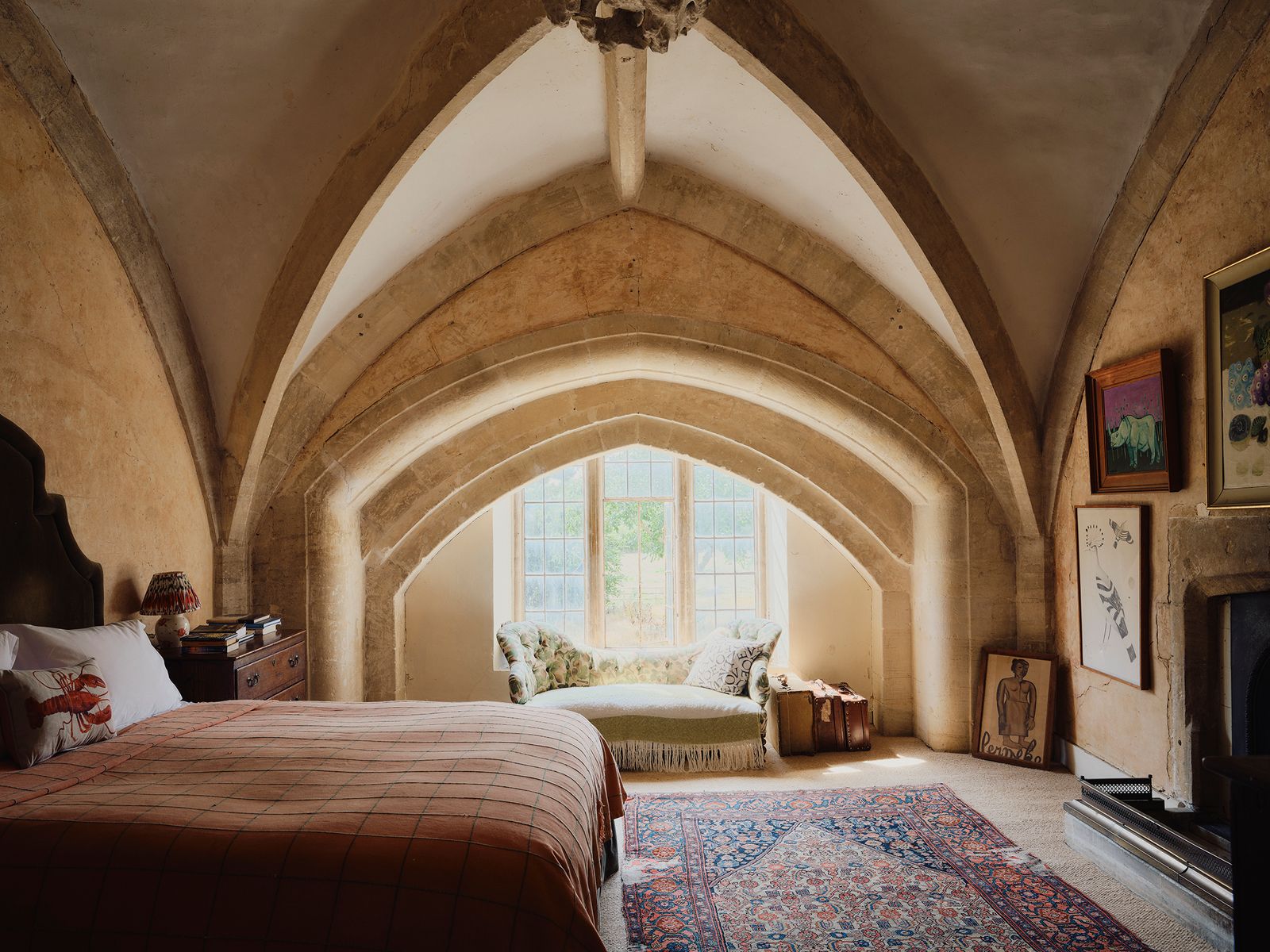 Gothic arches make a striking feature in the bedroom of artist Matthew Rice's house in Oxfordshire