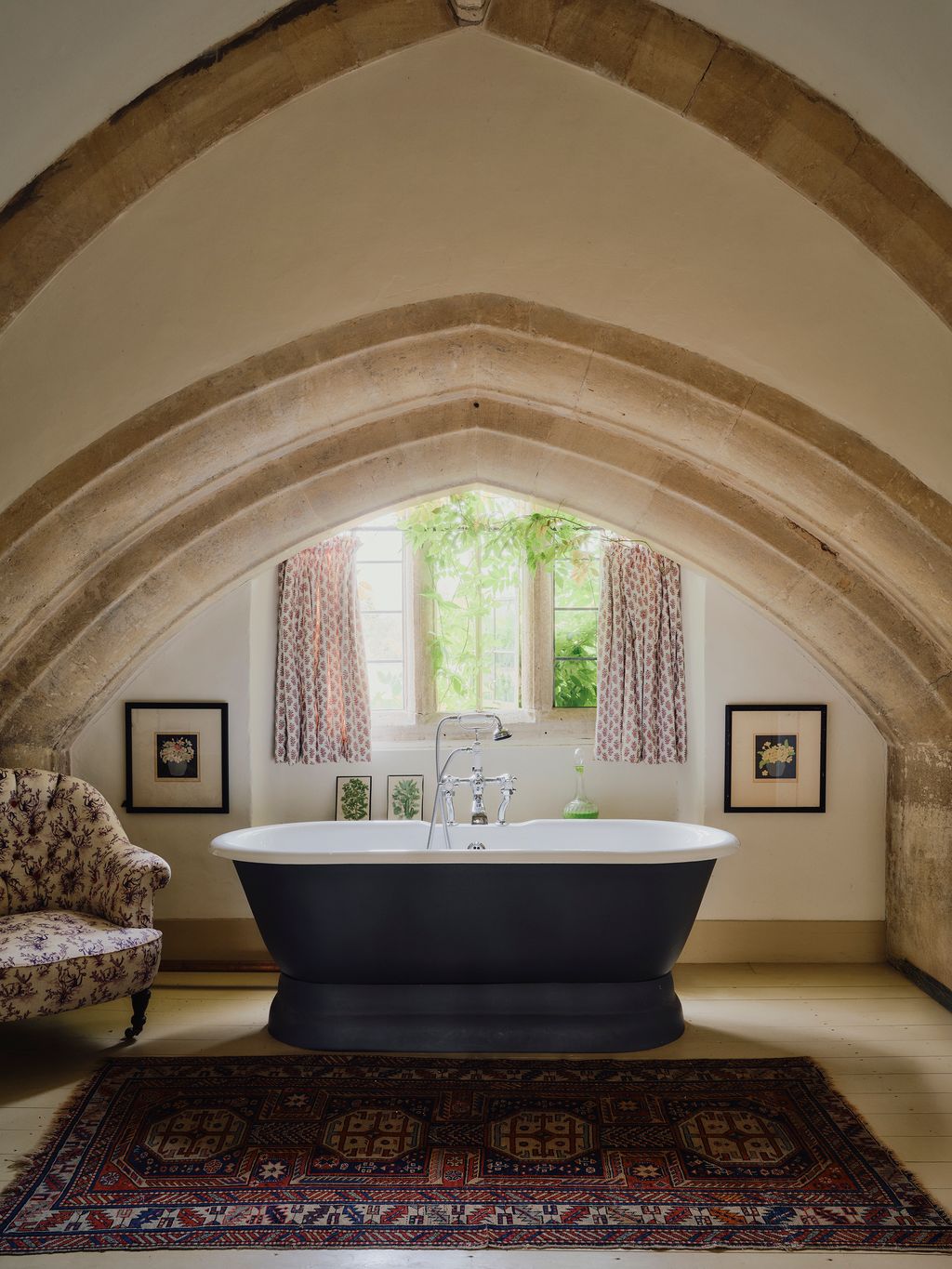 In Matthews bathroom a bathtub is tucked under soaring Gothic arches.