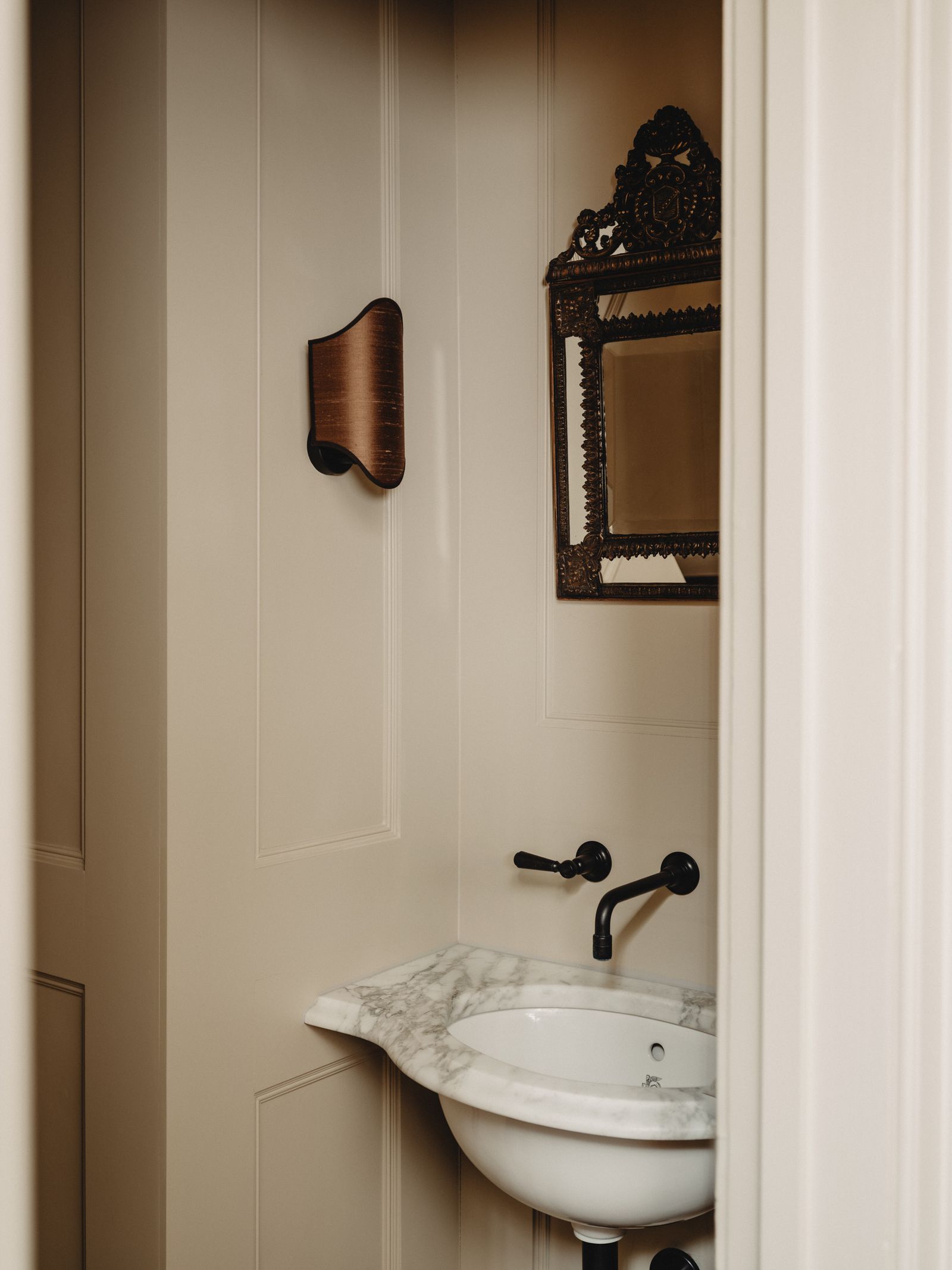 The guest loo has a custom made sink and wallmounted taps from Barber Wilson to make the most of the awkward space. A...