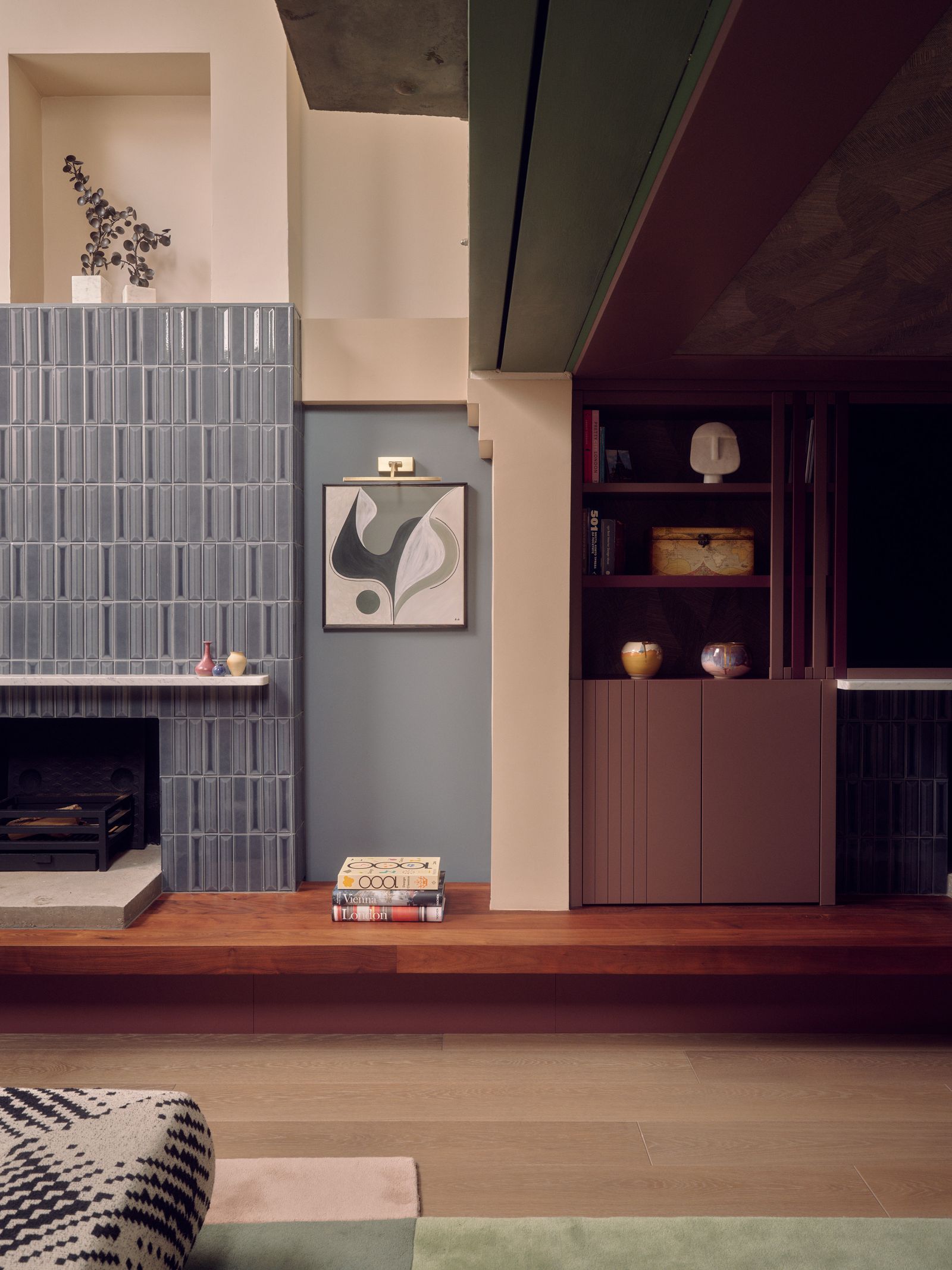 A bespoke sofa provides a link between the two spaces of the lowerground floor sitting room.