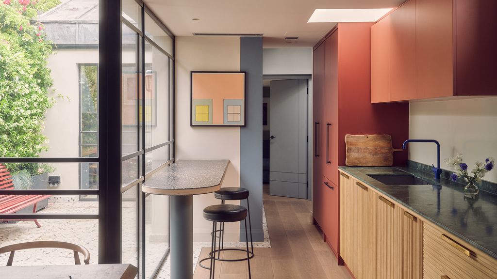 The artwork above the breakfast bar is a bespoke commission by the artist Dominic Denis.