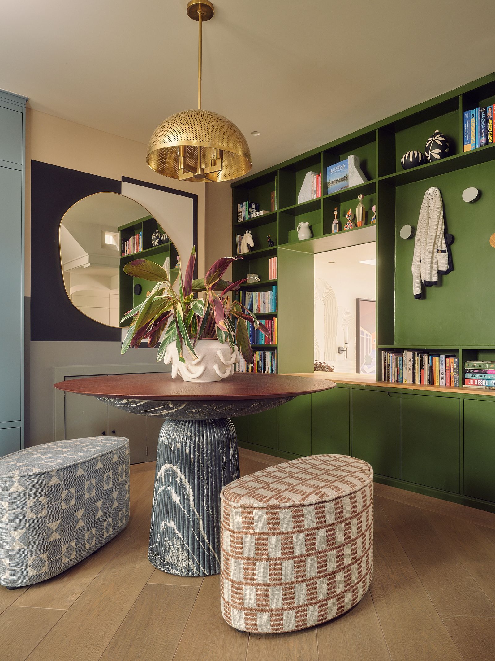 A ‘Tapio pendant light from Arteriors hangs above a table in the hallway. ‘We bought the table from Atkin amp Thyme and...