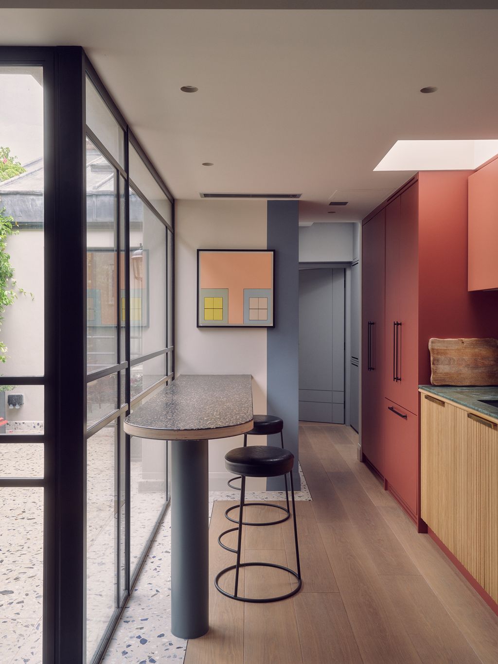 Edward Bulmer's ‘Inferior Grey on the walls combines with cupboards painted in ‘Picture Gallery Red and ‘Red Earth both...