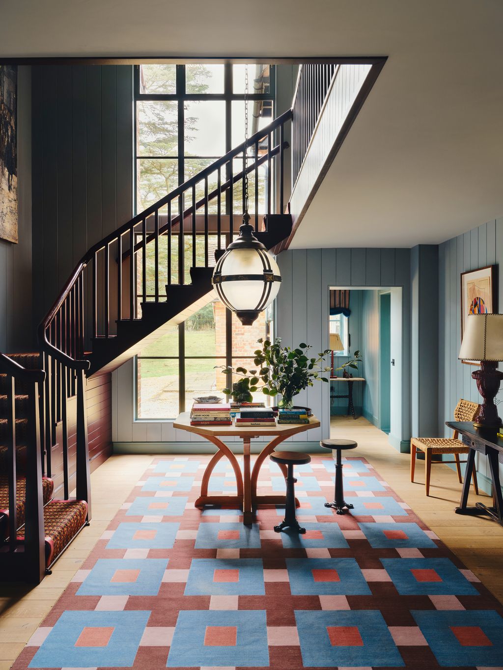 Panelling painted in ‘Blue Reef and the staircase in ‘Moorland both by Pure  Original pick up on the rug designed by...