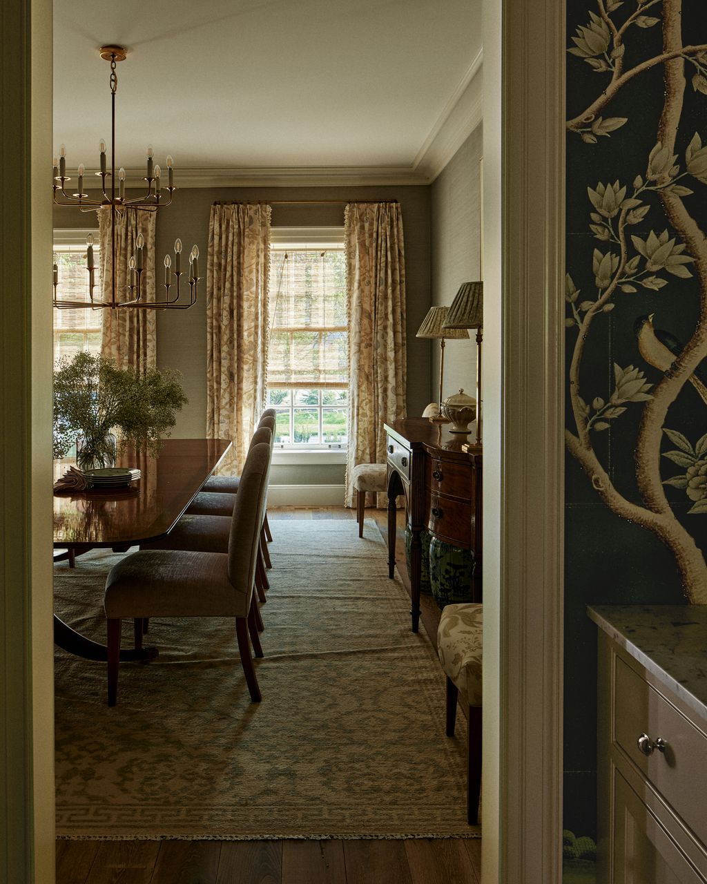 The antique Duncan Phyfe dining table is accompanied by custom chairs made by Whittington Company and upholsted in...