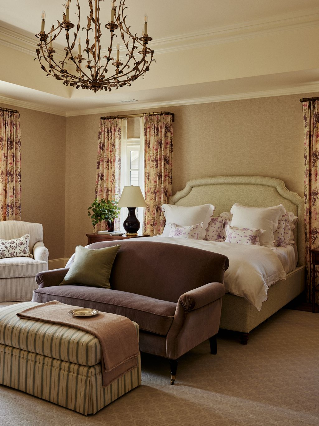 The principal bedroom exudes warmth. The luxurious sofa is upholstered in fabric by heritage brand Holland and Sherry....