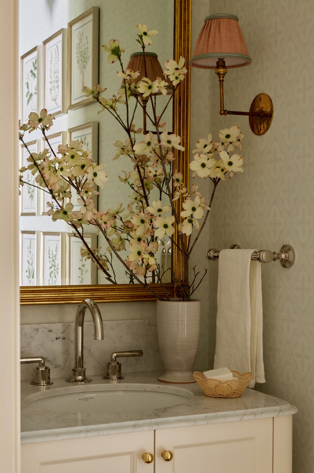 The vanity in the powder room was made bespoke by Whittington Company. A mirror by Scully and Scully hangs above it....