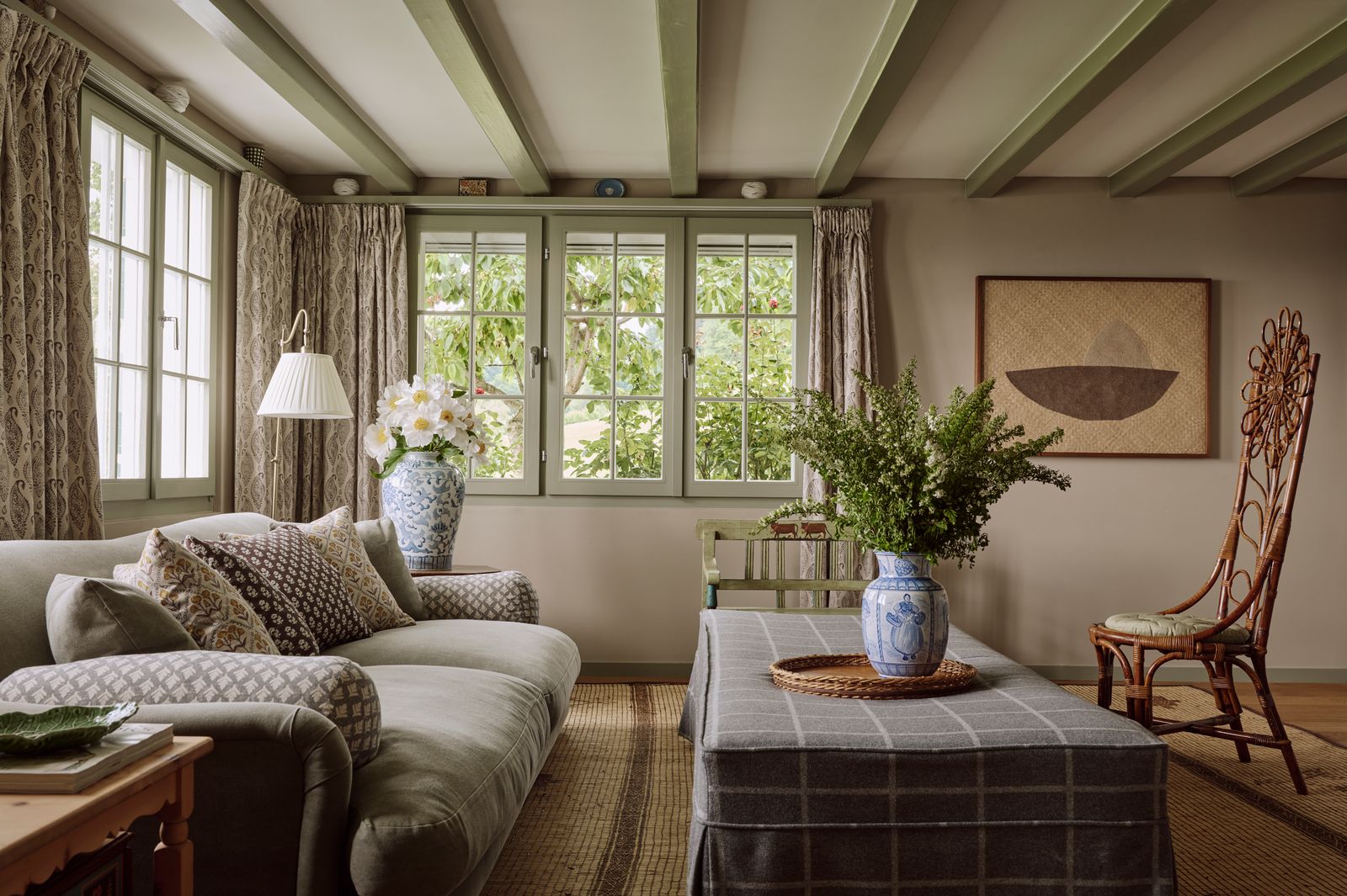 An artwork by Magda Skupinska one of a pair of rattan chairs from a local vintage shop and a Tuareg rug from Maison...