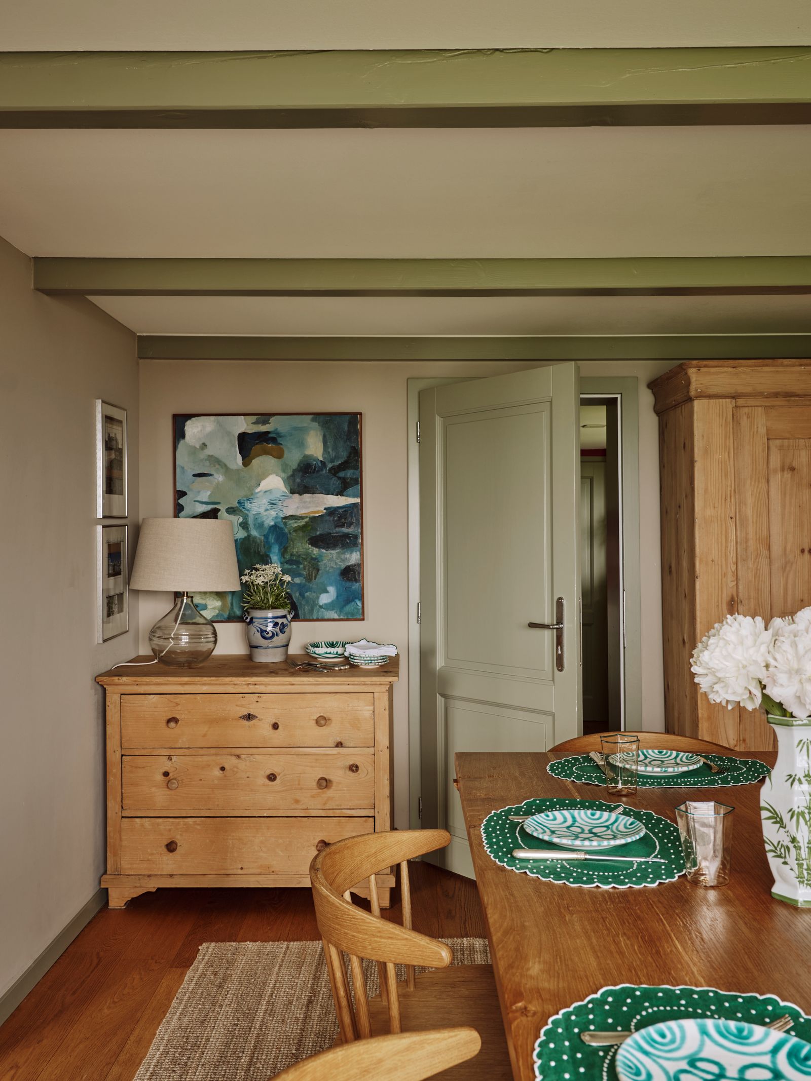 The typical Swiss pine furniture sourced locally gives the dining room a relaxed countryhouse feel. Green plates from...