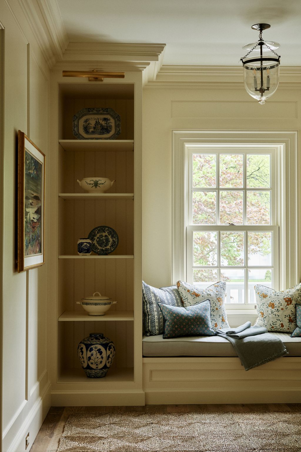 The lightfilled hallway upstairs has a cosy window seat filled with cushions from Claremont Robert Kime and Jasper Fabrics.