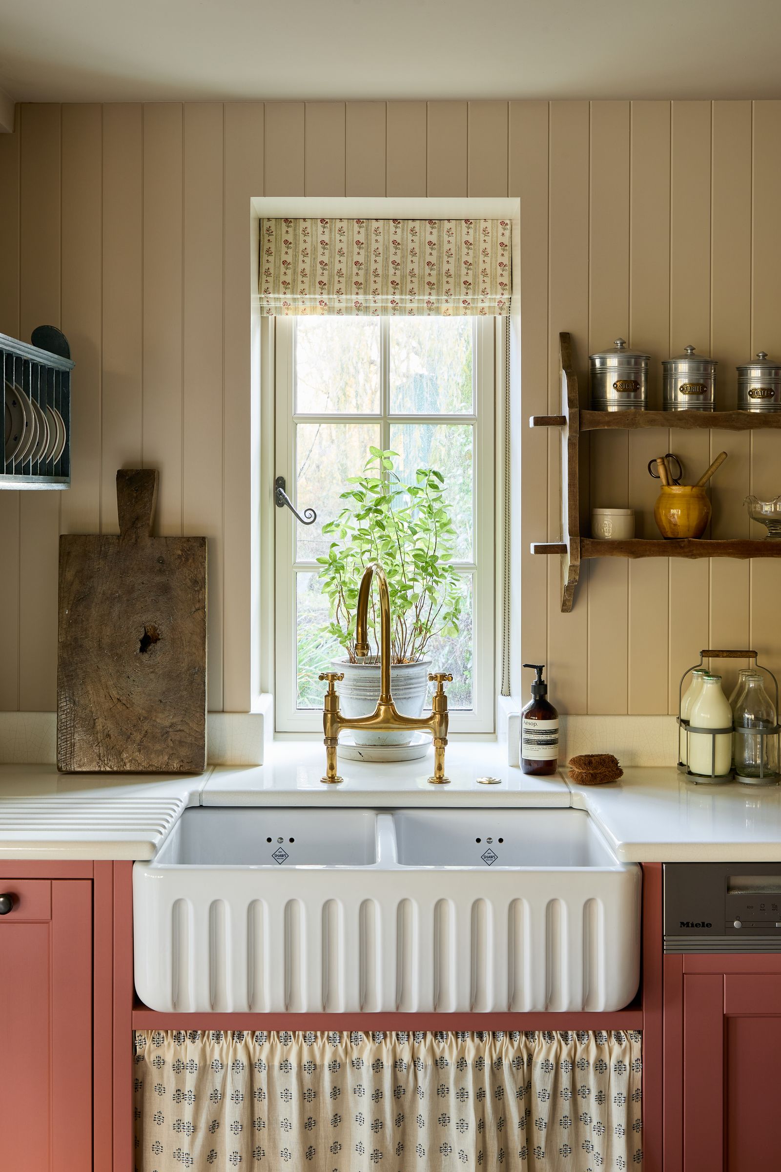 A flutedfront double bowl sink from Shaws is paired with a traditional brass mixer tap from DeVol in this 16thcentury...