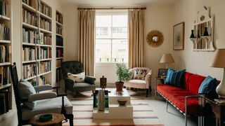The view into one half of Tarkas dualaspect sitting room. The floorboards have been painted in Farrow Ball ‘Blackened...