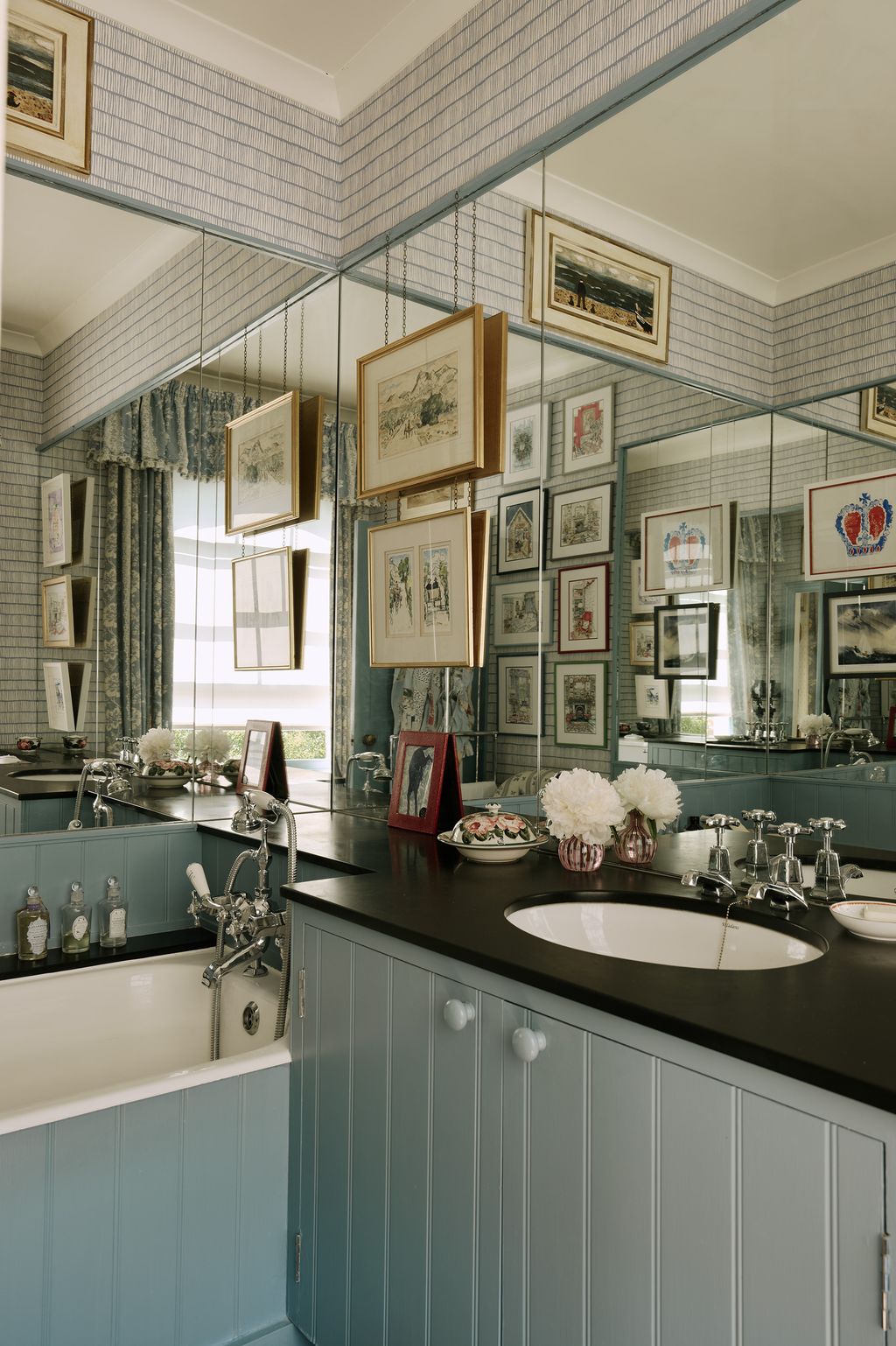 The little ensuite bathroom is made to feel larger thanks to the addition of a bright blue patterned wallpaper  ‘Crochet...