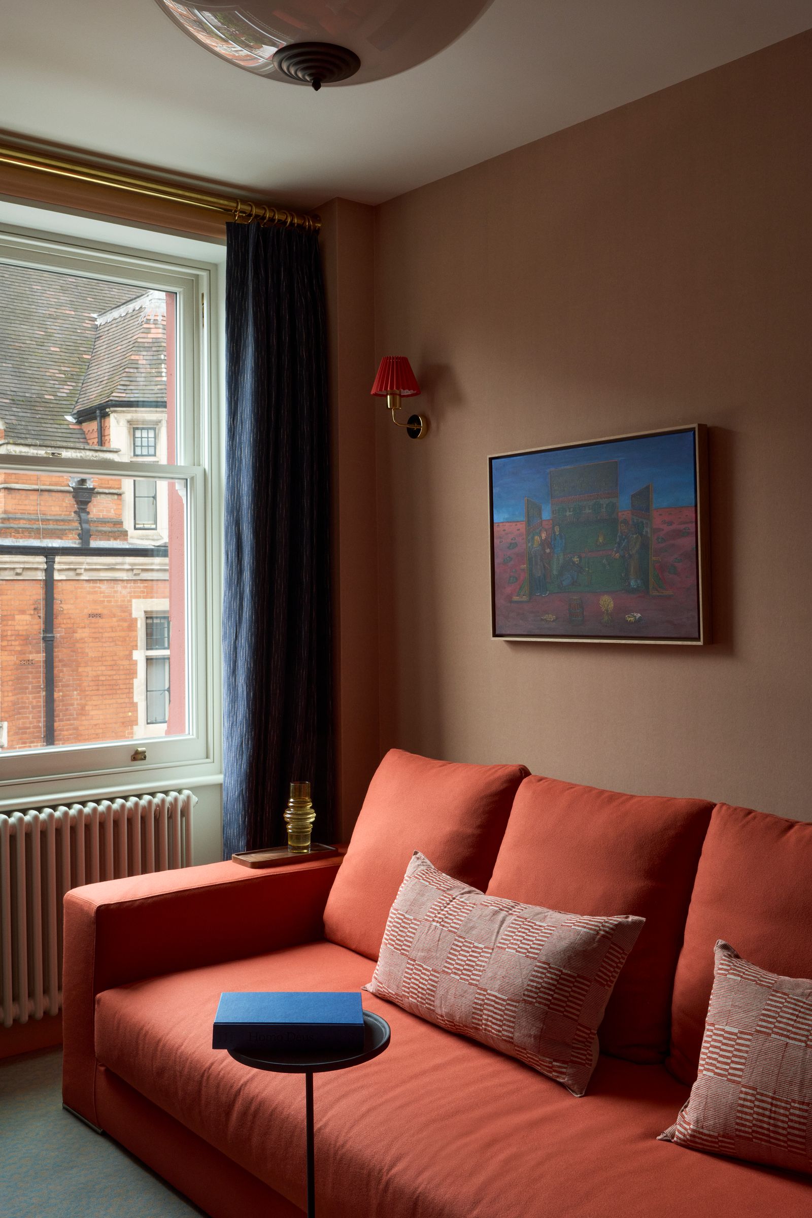 The sofa is an ‘Ananta model from Saba Italia. The cushions are by Louisa Loakes and the side table is from Zara Home.