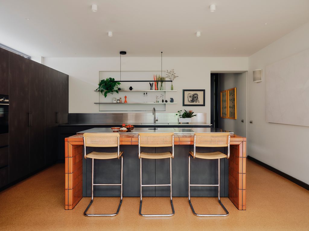 Designed with Eggersmann Design the kitchen features Cevica tiles and bar stools from Kempton. A large gesso piece by...