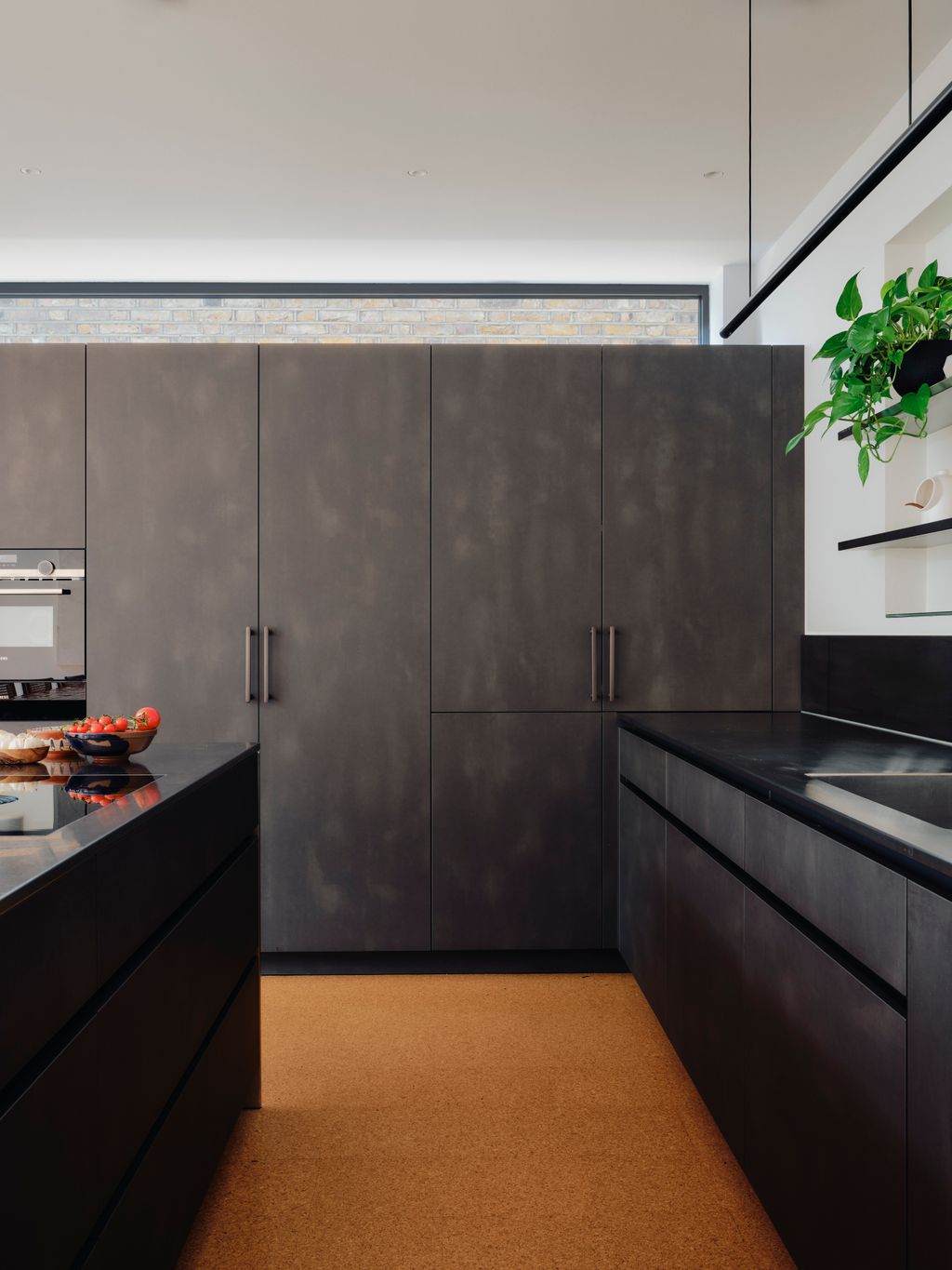 The sleek design of a Wästberg W181 Linier pendant complements a clerestory window that brings light into the room while...